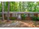 Charming brick home with a well-maintained lawn and mature trees at 1671 Drayton Woods Dr, Tucker, GA 30084