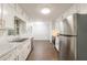 Modern kitchen with stainless steel appliances, ample counter space, and white cabinets at 1671 Drayton Woods Dr, Tucker, GA 30084