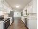Well-lit kitchen featuring stainless steel appliances, white cabinetry, and modern countertops at 1671 Drayton Woods Dr, Tucker, GA 30084