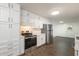 Stylish renovated kitchen featuring stainless steel appliances and white cabinetry at 1671 Drayton Woods Dr, Tucker, GA 30084