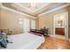 Cozy bedroom featuring hardwood floors with a view of an attached bathroom at 2380 Crescent Park Ct # 4, Atlanta, GA 30339