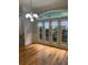 Bright dining area with hardwood floors, stylish lighting, and a wall of windows with outdoor views at 2380 Crescent Park Ct # 4, Atlanta, GA 30339