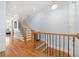 Bright foyer featuring hardwood floors, staircase with black iron spindles, and open access to other rooms at 2380 Crescent Park Ct # 4, Atlanta, GA 30339