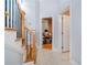 Hallway with wooden stairs, neutral tile flooring and an open doorway at 2380 Crescent Park Ct # 4, Atlanta, GA 30339
