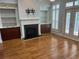 Inviting living space features hardwood floors, custom built-ins, fireplace, and double glass doors at 2380 Crescent Park Ct # 4, Atlanta, GA 30339