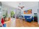 Bright living room featuring hardwood floors, a ceiling fan, a blue sofa and access to a patio at 2380 Crescent Park Ct # 4, Atlanta, GA 30339