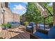 Inviting outdoor space with cozy wicker furniture on wood deck with a brick wall backdrop and overhead sunshade at 2380 Crescent Park Ct # 4, Atlanta, GA 30339