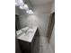 Bright bathroom featuring gray cabinets, double sinks, and modern fixtures at 442 Snow Owl Way, Lawrenceville, GA 30044