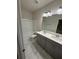 Bathroom featuring white countertops, gray cabinets and tile flooring at 442 Snow Owl Way, Lawrenceville, GA 30044