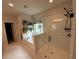 Bright bathroom featuring a glass-enclosed shower and soaking tub at 442 Snow Owl Way, Lawrenceville, GA 30044
