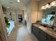 A luxurious bathroom with dual vanities, marble counters, and tile floors at 442 Snow Owl Way, Lawrenceville, GA 30044