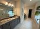 Bathroom with long marble vanity, soaker tub, and tiled shower at 442 Snow Owl Way, Lawrenceville, GA 30044