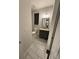 This bathroom features an undermount sink with gray cabinets and light tile flooring at 442 Snow Owl Way, Lawrenceville, GA 30044