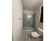 This bathroom features a glass-enclosed shower with a white subway tile backsplash at 442 Snow Owl Way, Lawrenceville, GA 30044