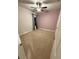 Carpeted bedroom with ceiling fan, window, and closet access at 442 Snow Owl Way, Lawrenceville, GA 30044