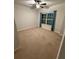 Bedroom featuring a ceiling fan, neutral walls and carpet, and a window with blue curtains at 442 Snow Owl Way, Lawrenceville, GA 30044