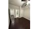 Bright bedroom featuring hardwood floors with an adjacent bathroom and closet space at 442 Snow Owl Way, Lawrenceville, GA 30044