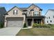 Charming two-story brick home with a well-manicured lawn and a two-car garage at 442 Snow Owl Way, Lawrenceville, GA 30044