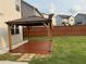 Wooden gazebo with a deck and string lights in a fenced backyard at 442 Snow Owl Way, Lawrenceville, GA 30044
