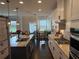 Open kitchen featuring granite countertops, an island with seating, and stainless appliances at 442 Snow Owl Way, Lawrenceville, GA 30044