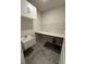 Laundry room with a sink, countertop space, cabinets, and gray tile floors at 442 Snow Owl Way, Lawrenceville, GA 30044