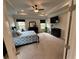 Spacious main bedroom with tray ceiling, fan, and large windows at 442 Snow Owl Way, Lawrenceville, GA 30044