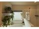 Close-up on the glass shower and soaking tub with neutral tile at 442 Snow Owl Way, Lawrenceville, GA 30044
