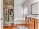 Bathroom featuring a combined shower-tub with glass door, vanity, and modern fixtures at 105 Silver Trce, Dallas, GA 30157