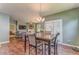 Open concept dining room adjacent to the kitchen and living room with a chandelier and table at 105 Silver Trce, Dallas, GA 30157