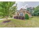 Charming home featuring a stone facade, two-car garage, manicured lawn, and meticulously maintained landscaping at 105 Silver Trce, Dallas, GA 30157