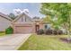 Charming home featuring a stone facade, two-car garage, manicured lawn, and meticulously maintained landscaping at 105 Silver Trce, Dallas, GA 30157