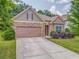 Charming home featuring a stone facade, two-car garage, manicured lawn, and meticulously maintained landscaping at 105 Silver Trce, Dallas, GA 30157