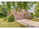 Charming home featuring a stone facade, two-car garage, manicured lawn, and meticulously maintained landscaping at 105 Silver Trce, Dallas, GA 30157