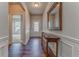 A stunning foyer features hardwood floors, elegant wainscoting, a console table, and a decorative mirror at 105 Silver Trce, Dallas, GA 30157