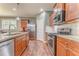 This kitchen features stainless steel appliances, granite countertops, wood cabinets, and wood floors at 105 Silver Trce, Dallas, GA 30157