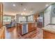 A modern kitchen features stainless steel appliances, a center island, wood floors, and a seamless flow to living area at 105 Silver Trce, Dallas, GA 30157