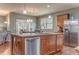 A modern kitchen features stainless steel appliances, a center island, wood floors, and a seamless flow to living area at 105 Silver Trce, Dallas, GA 30157