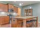Well-lit kitchen boasting granite countertops, stainless steel appliances, and an island with seating at 105 Silver Trce, Dallas, GA 30157