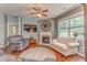 Relaxing living room with a fireplace, plush seating, hardwood floors, and a large window at 105 Silver Trce, Dallas, GA 30157
