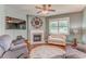 Comfortable living room with a fireplace, large window, ceiling fan and ample seating at 105 Silver Trce, Dallas, GA 30157