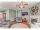 Cozy living room featuring a fireplace, ceiling fan, hardwood floors, and comfortable seating at 105 Silver Trce, Dallas, GA 30157