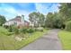 Long paved driveway leading to the back of the house with a deck at 1239 Brentwood Ct, Douglasville, GA 30135
