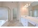 Bright bathroom with dual vanity sinks, tile floors, and glass shower doors at 1239 Brentwood Ct, Douglasville, GA 30135