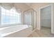 Primary bathroom featuring a garden tub and a glass enclosed shower at 1239 Brentwood Ct, Douglasville, GA 30135