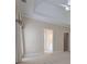 Spacious primary bedroom with tray ceilings, carpeted floors and ensuite bathroom entrance at 1239 Brentwood Ct, Douglasville, GA 30135