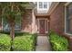 Charming brick home featuring a welcoming front door, walkway and manicured landscaping at 1239 Brentwood Ct, Douglasville, GA 30135