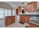 Traditional kitchen features a center island, granite countertops, and wooden cabinets at 1239 Brentwood Ct, Douglasville, GA 30135