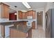 Bright kitchen with granite counters, an island, stainless steel refrigerator, and tile floors at 1239 Brentwood Ct, Douglasville, GA 30135