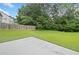 Large grassy backyard with a partial view of a concrete patio and a tall wooden fence for privacy at 3609 Indigo Creek Nw Trl, Kennesaw, GA 30144