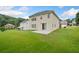 Expansive backyard with a patio, lush green grass, and privacy from the surrounding trees and homes at 3609 Indigo Creek Nw Trl, Kennesaw, GA 30144